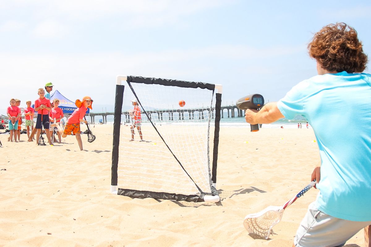 A beachsports Camp counselor with a safety flotation device with kids at summer camp at the Ocean shore