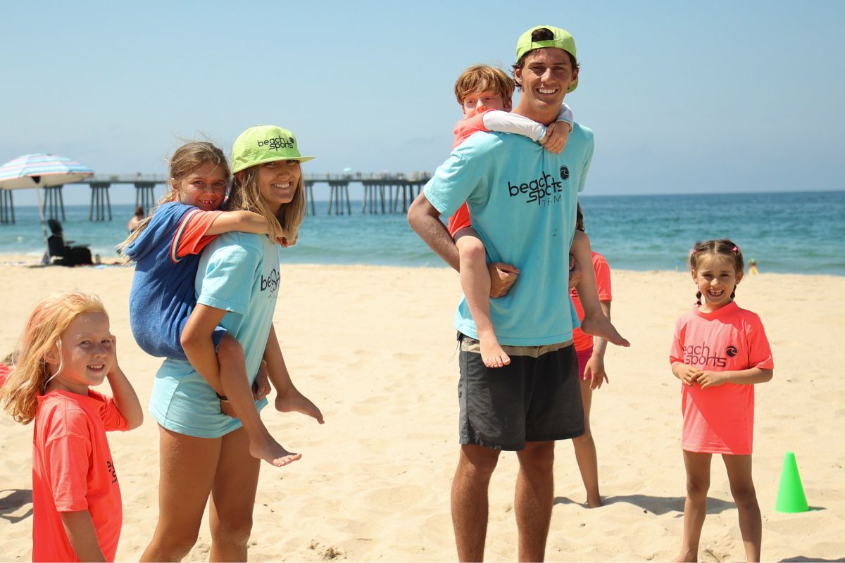 Two sports camp counselors in Hermosa Beach summer beach camp with five kids